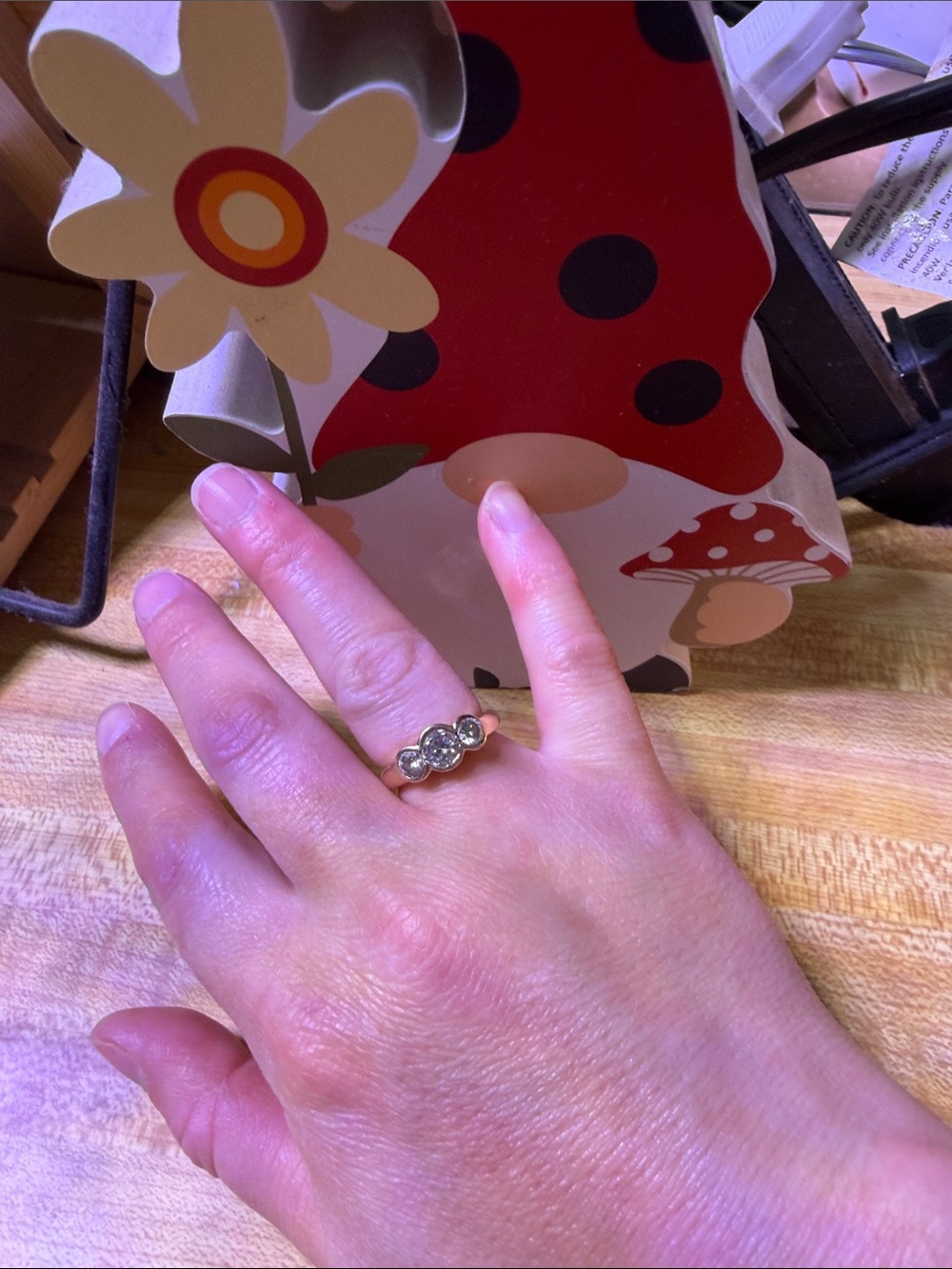 14k gold  3 stone diamond ring in a bezel setting
